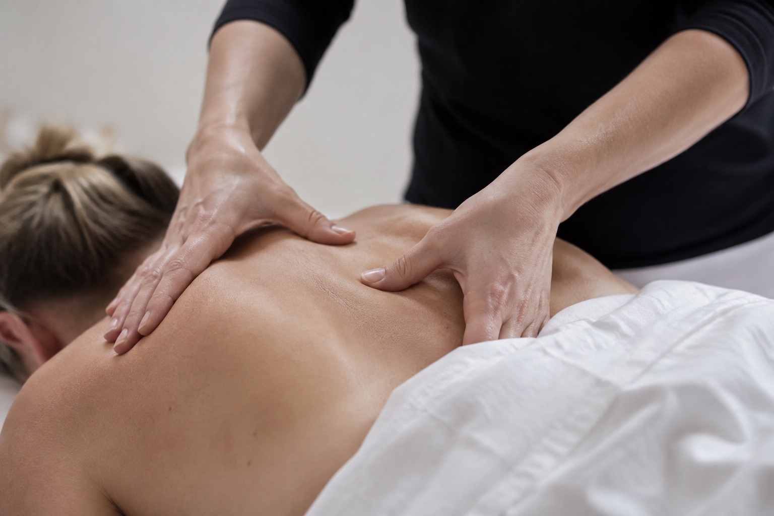 Close-up of a therapist’s hands during a professional back massage